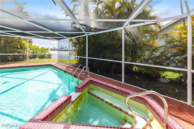 view of swimming pool featuring a lanai and a pool with connected hot tub