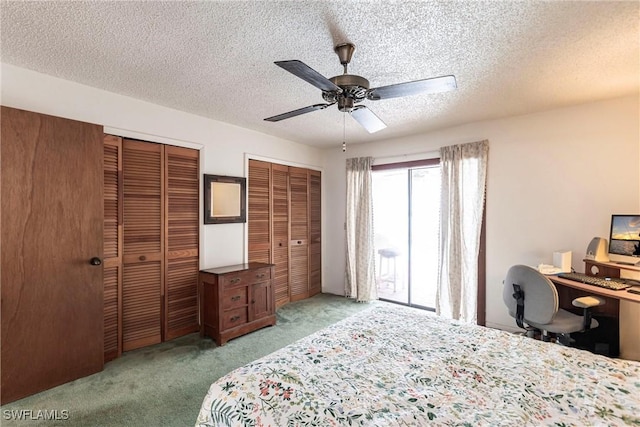 bedroom with a textured ceiling, ceiling fan, carpet, and multiple closets