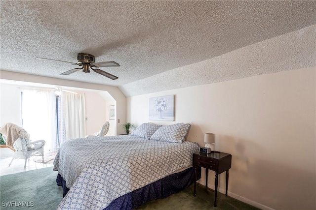 bedroom featuring carpet, ceiling fan, lofted ceiling, and a textured ceiling