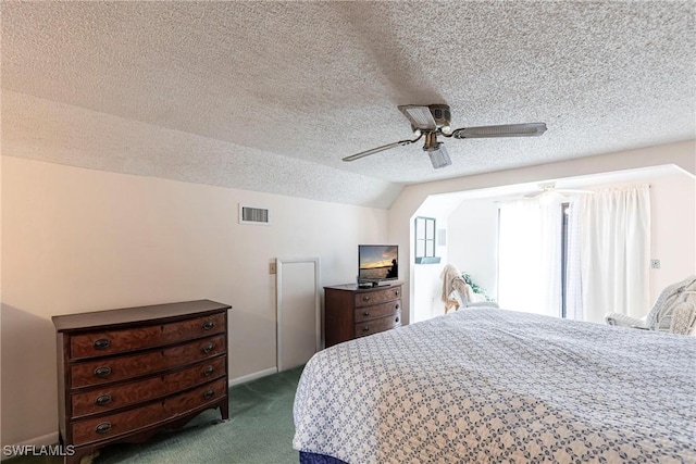 bedroom featuring visible vents, dark carpet, vaulted ceiling, a textured ceiling, and ceiling fan