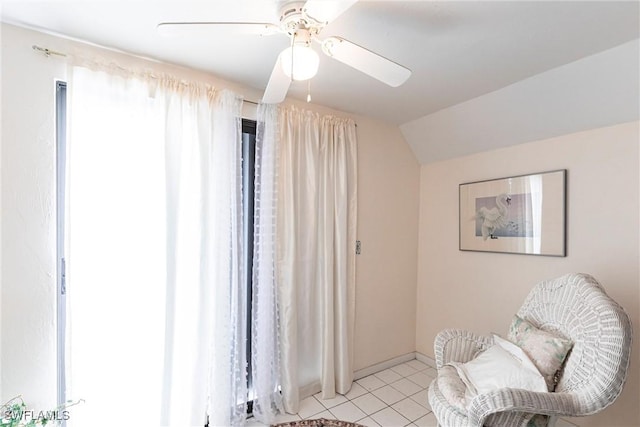 sitting room with light tile patterned floors, vaulted ceiling, a ceiling fan, and baseboards