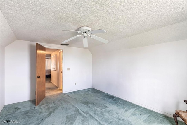 additional living space with carpet, lofted ceiling, visible vents, ceiling fan, and a textured ceiling