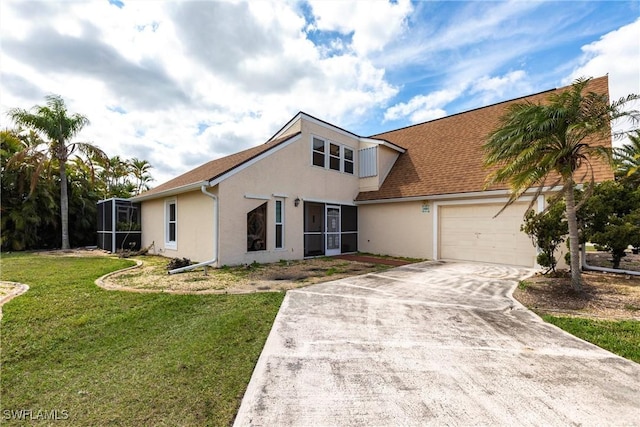 view of front of home with concrete driveway, glass enclosure, an attached garage, a front lawn, and stucco siding