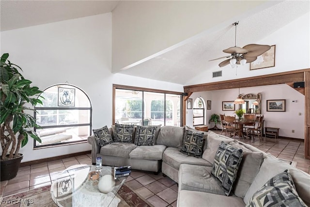 living room with visible vents, baseboards, ceiling fan, tile patterned flooring, and high vaulted ceiling