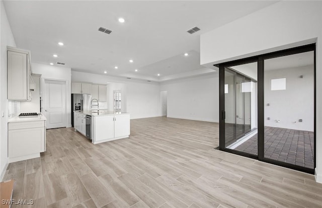 18372 Ridgeline Dr, Estero, FL 33928 - kitchen with light wood-style floors, open floor plan, and visible vents