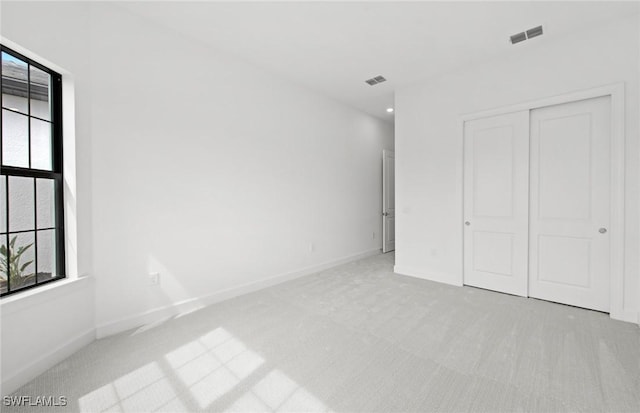 18372 Ridgeline Dr, Estero, FL 33928 - unfurnished bedroom with a closet, visible vents, and light colored carpet