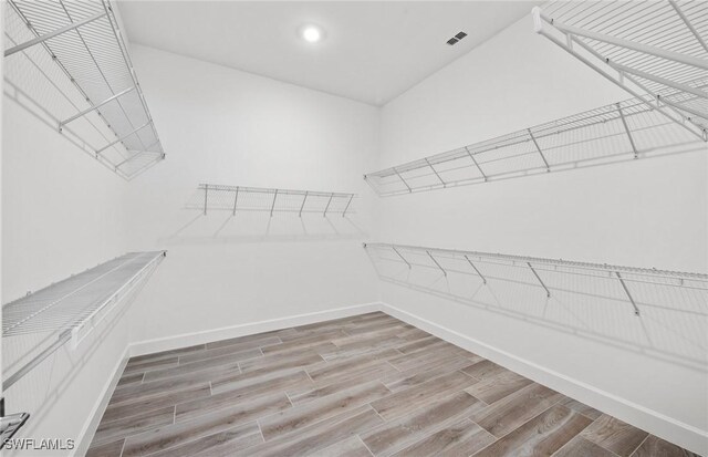 18372 Ridgeline Dr, Estero, FL 33928 - spacious closet with visible vents and wood finished floors