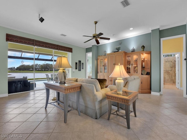 living room featuring light tile patterned floors, ornamental molding, and visible vents