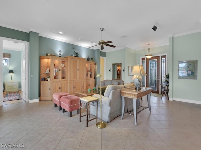 living room with ornamental molding, ceiling fan, baseboards, and light tile patterned floors