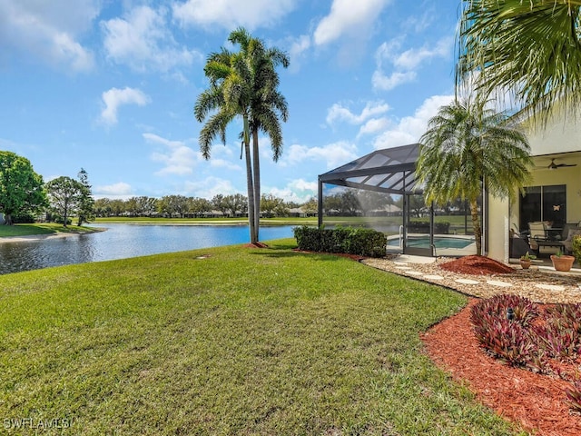 exterior space featuring glass enclosure, a water view, and an outdoor pool