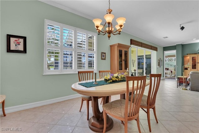 dining area with plenty of natural light, light tile patterned flooring, and crown molding