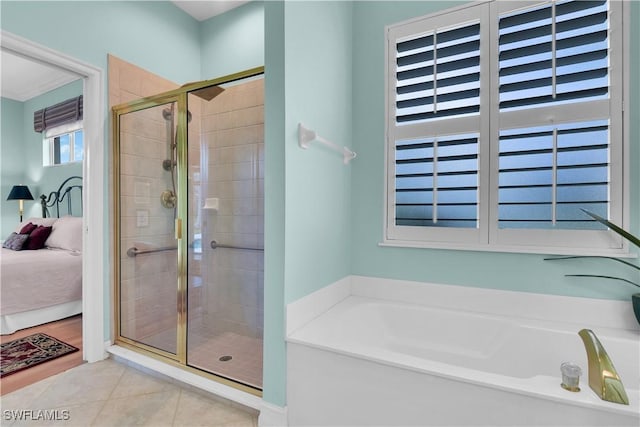 full bathroom with a stall shower, ensuite bath, tile patterned flooring, and a bath