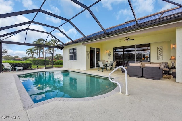 pool featuring an outdoor hangout area, a patio, ceiling fan, and glass enclosure