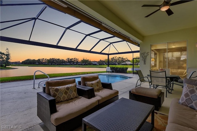 pool at dusk featuring an outdoor pool, a patio, a lanai, outdoor dining area, and an outdoor living space