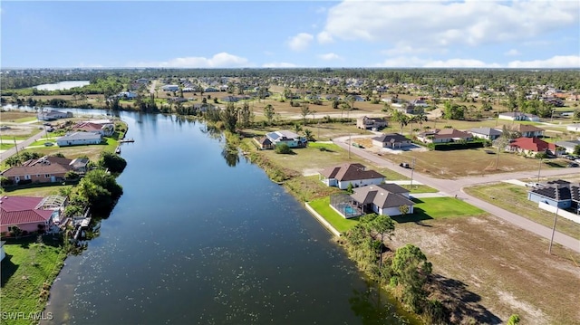 drone / aerial view featuring a water view and a residential view