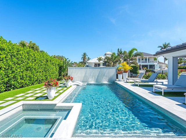 view of pool with a patio, fence, a fenced in pool, and an in ground hot tub