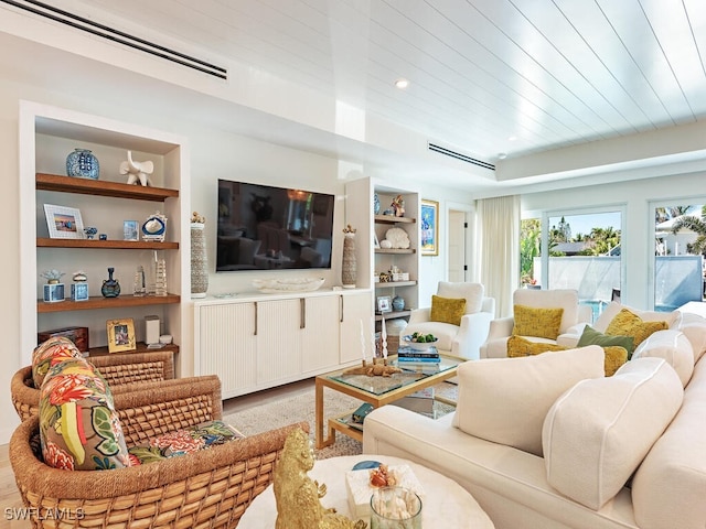 living room with built in shelves, recessed lighting, wood ceiling, and light wood-type flooring