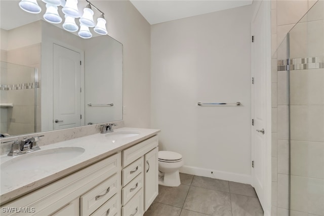 full bath with baseboards, a sink, toilet, and tile patterned floors