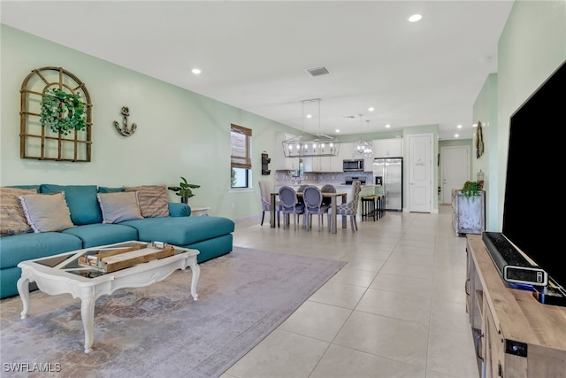 living area featuring recessed lighting, visible vents, and light tile patterned floors