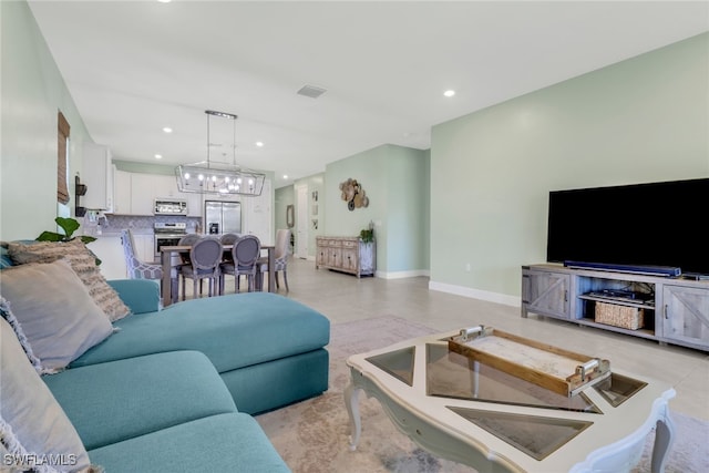 living room featuring baseboards, an inviting chandelier, visible vents, and recessed lighting