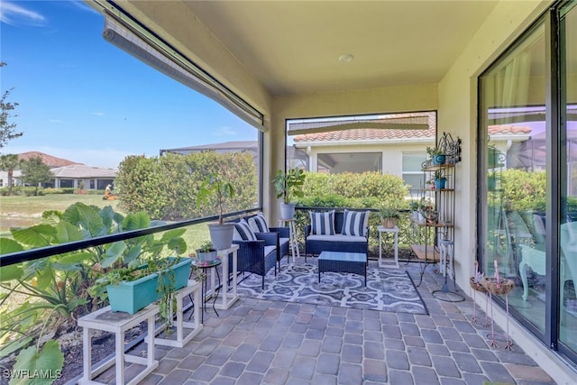 balcony featuring a sunroom and an outdoor living space