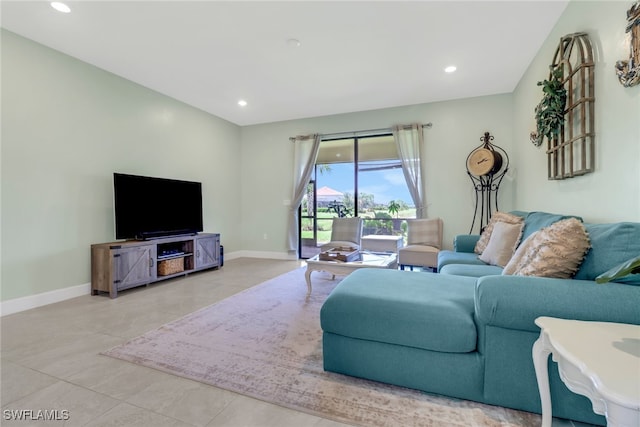 living room with light tile patterned floors, baseboards, and recessed lighting