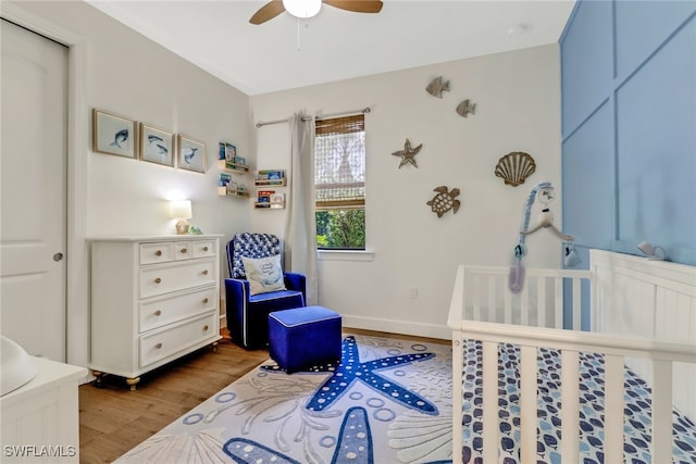 bedroom with ceiling fan, baseboards, and wood finished floors