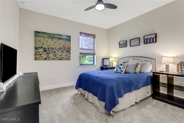 bedroom with a ceiling fan, baseboards, and carpet flooring