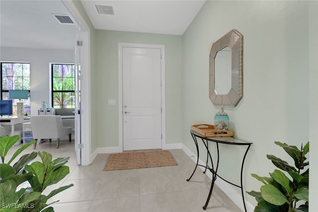 entrance foyer with baseboards, visible vents, and light tile patterned flooring