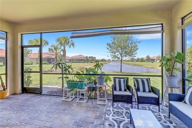 unfurnished sunroom featuring a water view