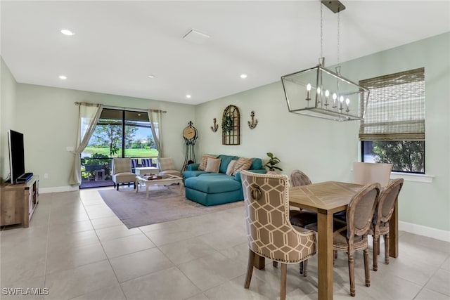 dining area featuring light tile patterned flooring, baseboards, an inviting chandelier, and recessed lighting