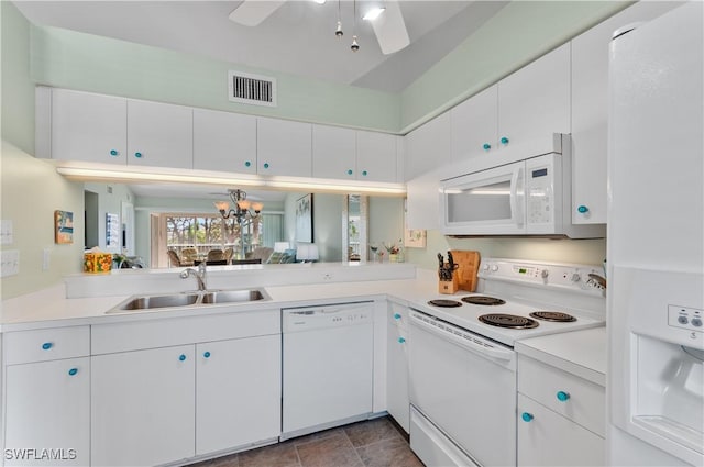 kitchen featuring white appliances, light countertops, visible vents, and a sink