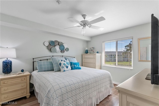 bedroom featuring baseboards, dark wood-style flooring, and ceiling fan