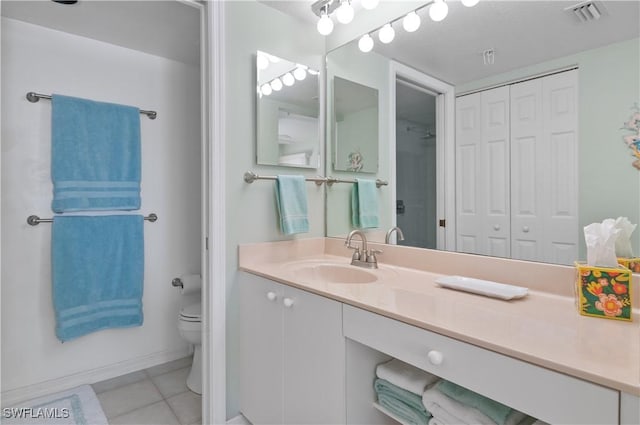 bathroom featuring vanity, visible vents, a closet, tile patterned floors, and toilet