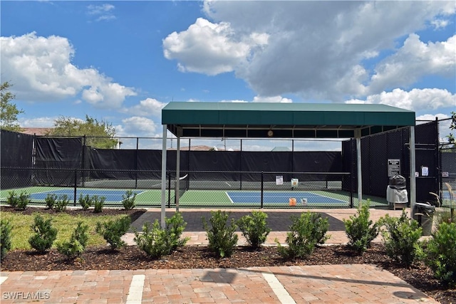 view of sport court featuring fence