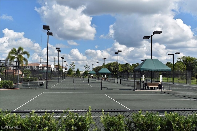 view of tennis court featuring fence