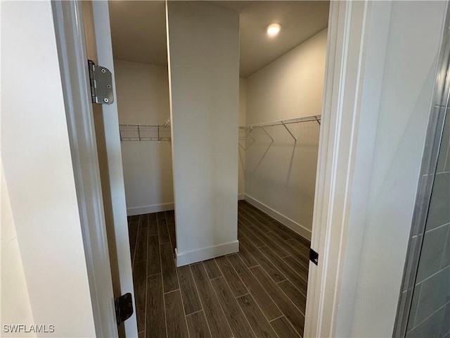 spacious closet with wood finish floors