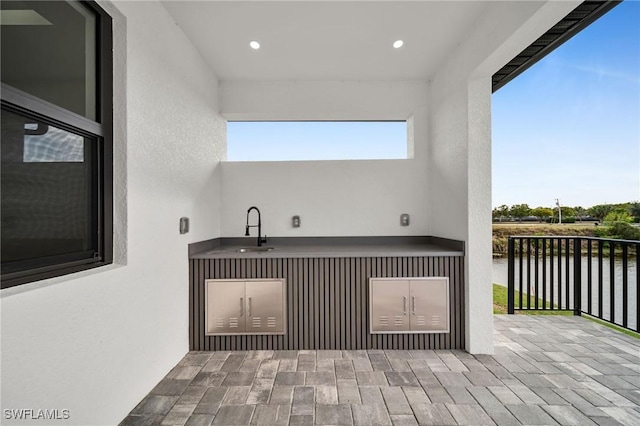 interior space with a water view and a sink