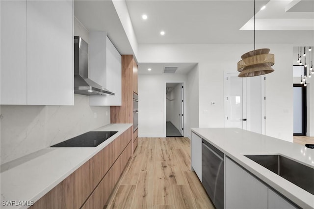 kitchen featuring white cabinets, dishwasher, wall chimney exhaust hood, modern cabinets, and light countertops