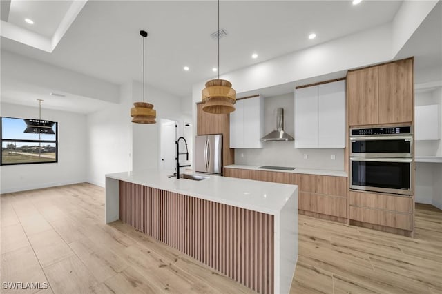 kitchen with pendant lighting, light countertops, appliances with stainless steel finishes, white cabinetry, and modern cabinets