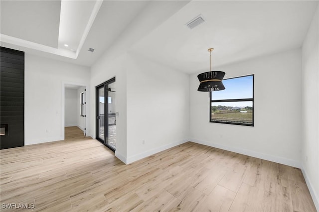 spare room featuring light wood-type flooring, visible vents, baseboards, and recessed lighting