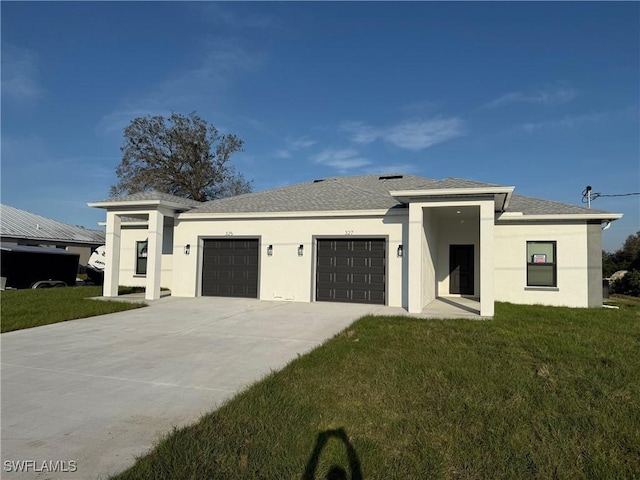 view of front facade featuring a garage, driveway, a front lawn, and stucco siding