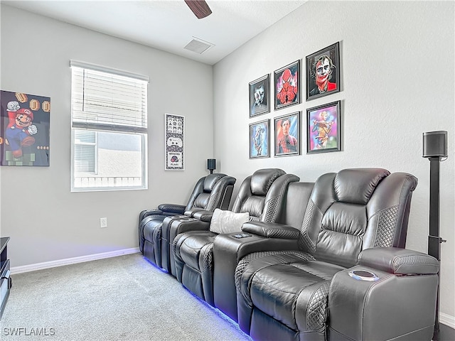 cinema with baseboards, carpet, visible vents, and a ceiling fan