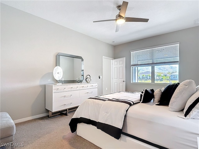 bedroom featuring baseboards, a ceiling fan, and light colored carpet