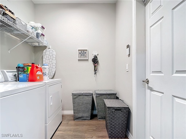 laundry area with light wood-style floors, laundry area, washer and clothes dryer, and baseboards