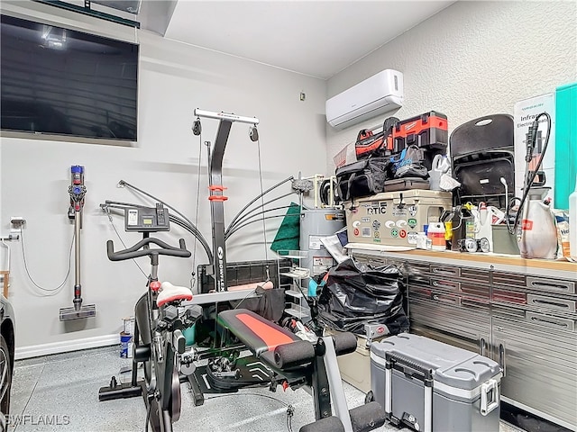 exercise room featuring an AC wall unit