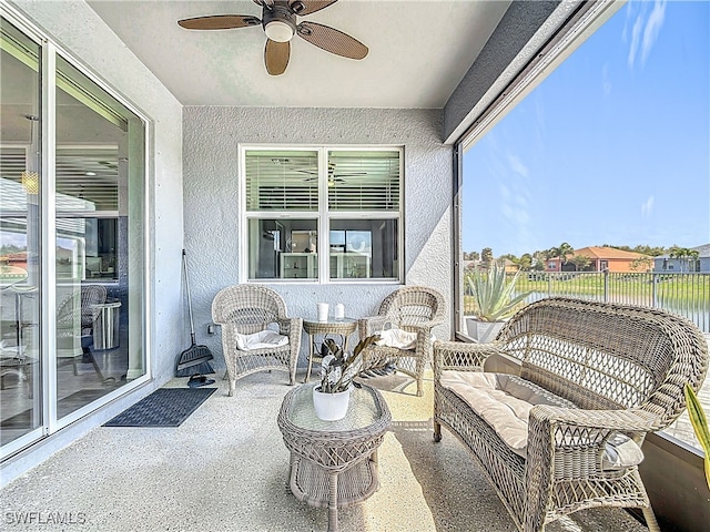 sunroom featuring ceiling fan