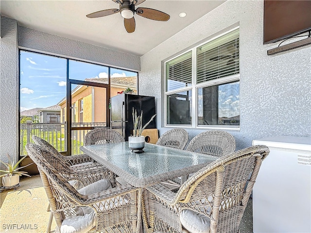 sunroom featuring a ceiling fan