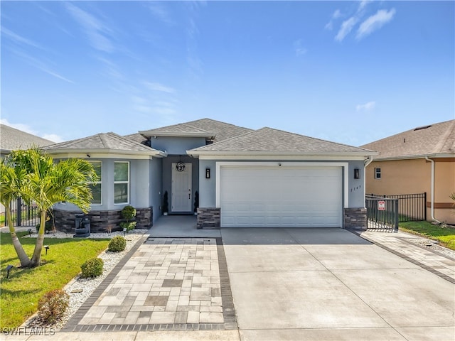 view of front of house with stone siding, driveway, and stucco siding