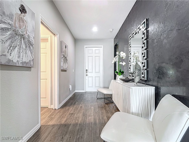 entryway with wood finished floors and baseboards